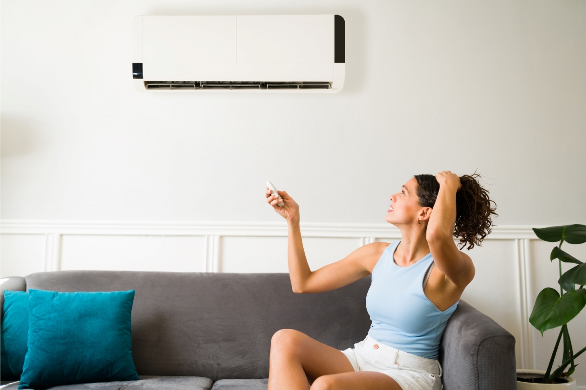 frustrated woman with broken air conditioner