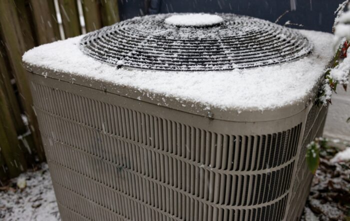 heat pump air conditioner frosted on top with snow