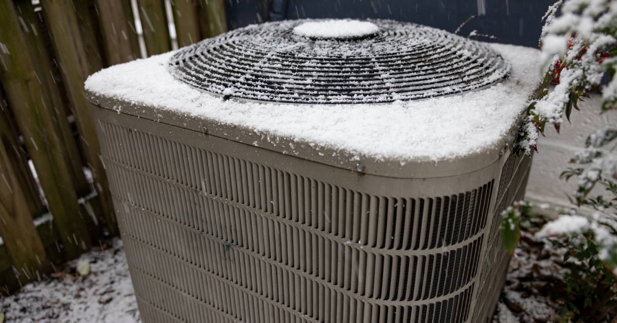 heat pump air conditioner frosted on top with snow